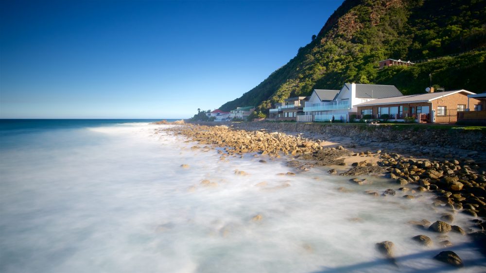 Beach, cliffs and home on the coast of Victoria Bay Beach in South Africa
