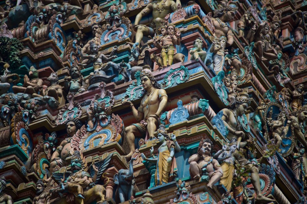 Intricate blue, pink, and rose sculptures on the outside of the Kapalishvara Temple in Chennai