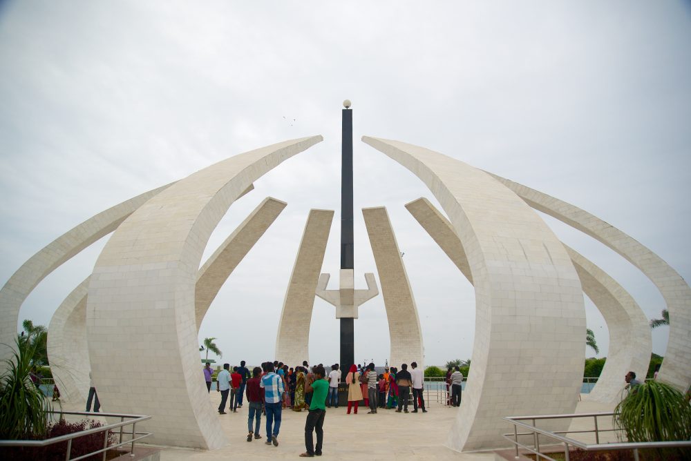 People visiting the MGR Memorial at Marina Beach in Chennai, a white marble sculpture shaped like an open flower