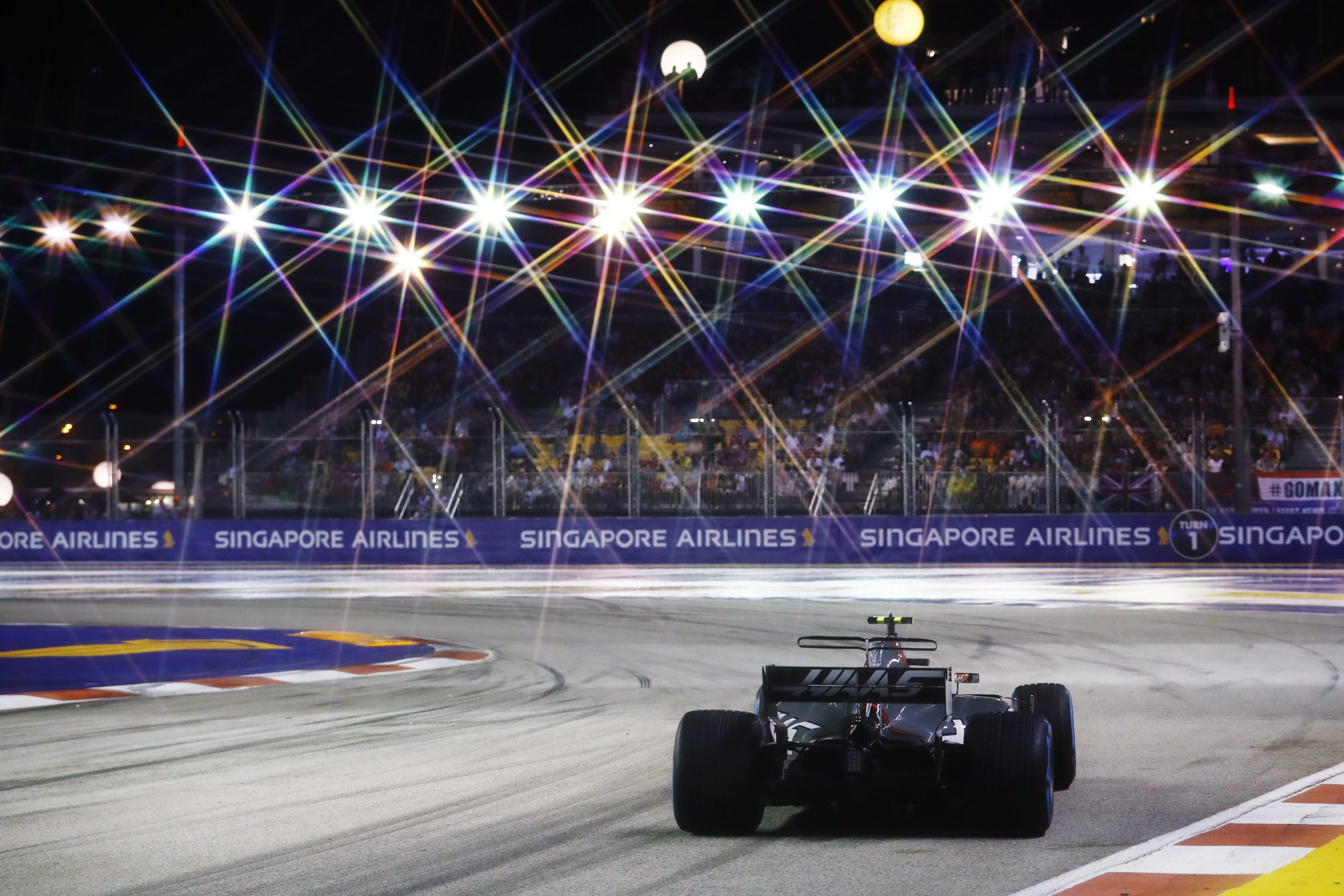 Racecar on Formula 1 track at night