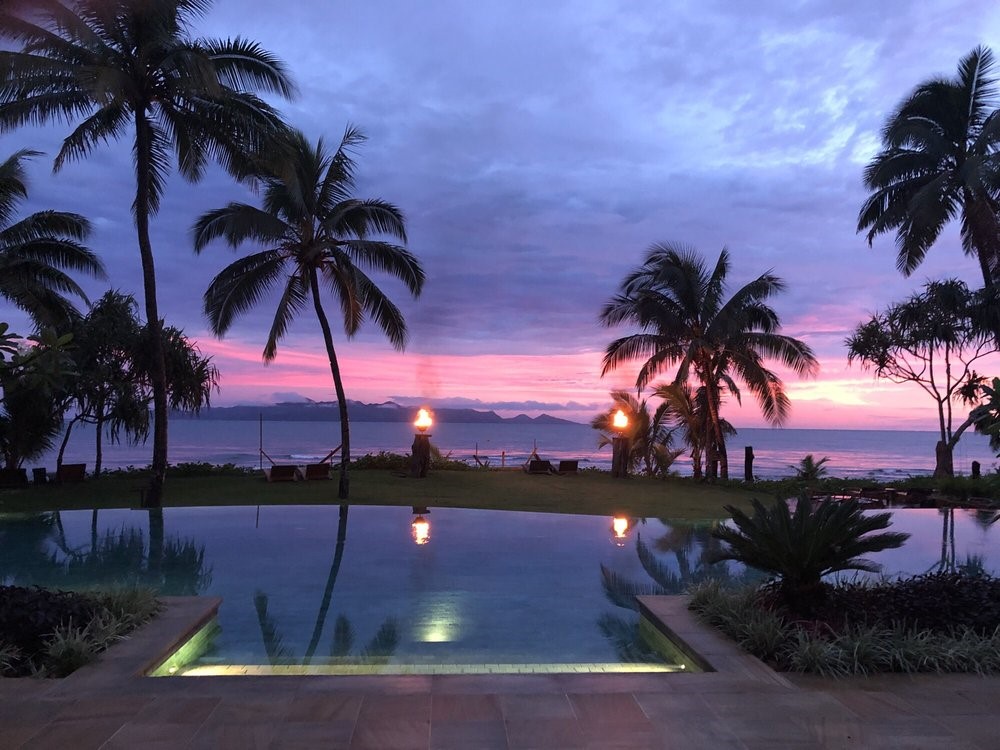 Pool area of Nanuku Auberge Resort at sunset
